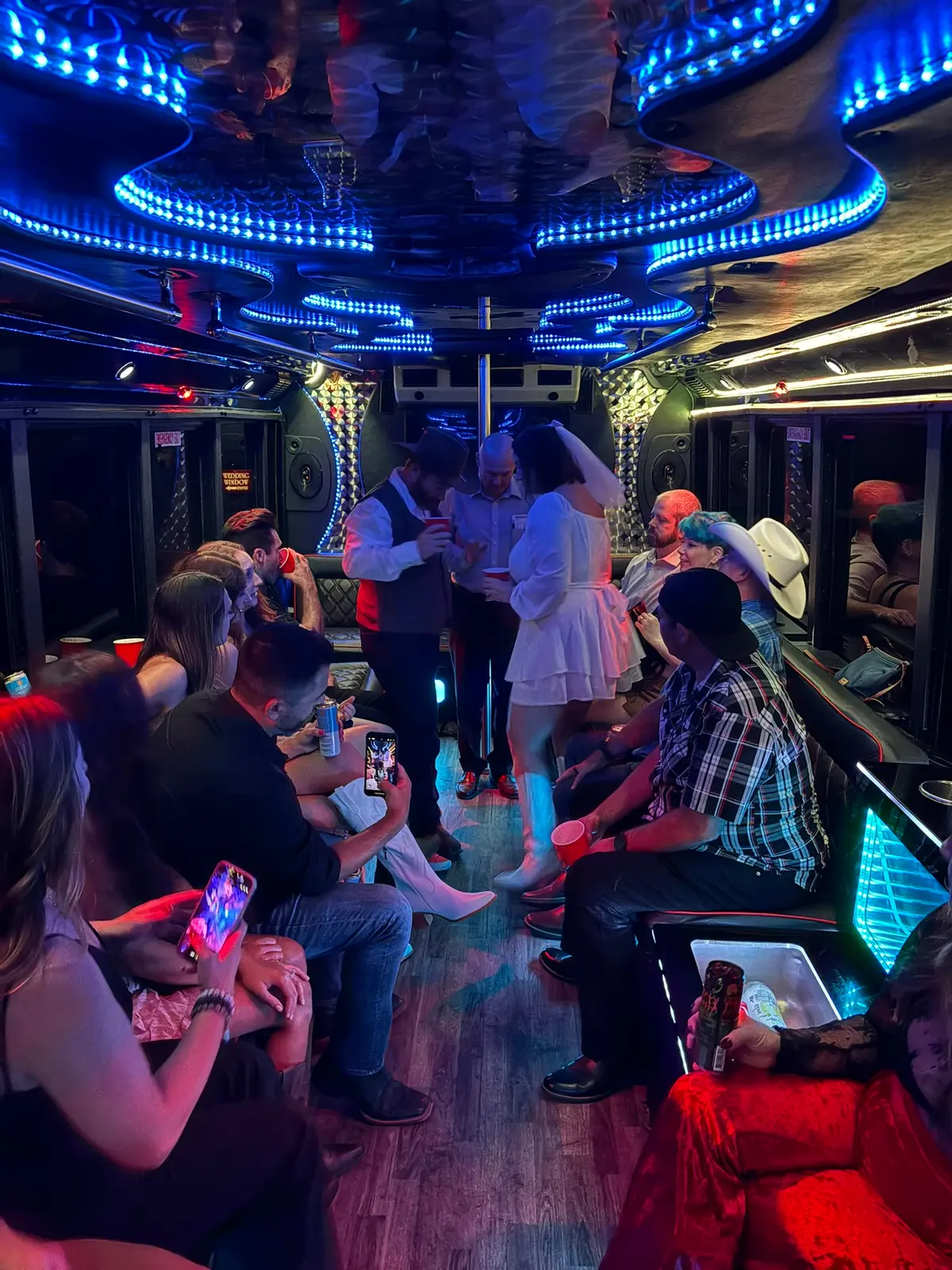 Wedding couple celebrating on party bus